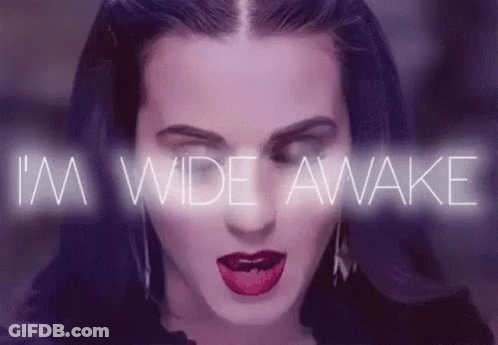 A Close Up Of A Woman 'S Face With The Words `` I 'M Wide Awake '' Coming Out Of Her Mouth . GIF