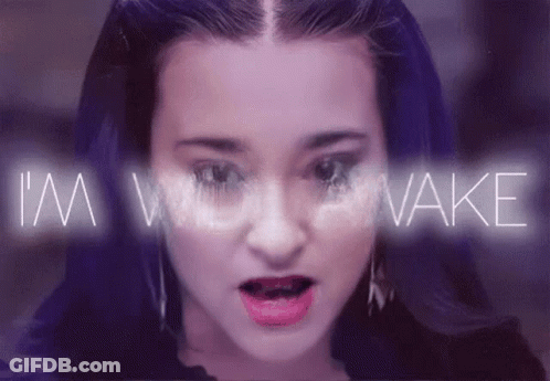 A Close Up Of A Woman 'S Face With The Words I 'M Woke Behind Her GIF