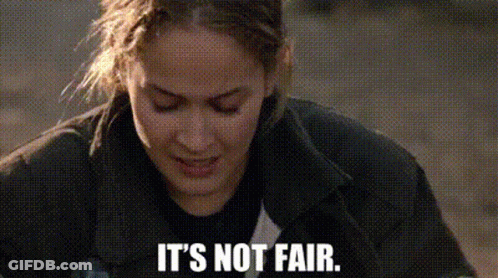 A Close Up Of A Woman 'S Face With The Words `` It 'S Not Fair '' Written Below Her . GIF