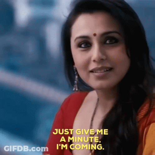 A Close Up Of A Woman 'S Face With The Words `` Just Give Me A Minute , I 'M Coming '' GIF