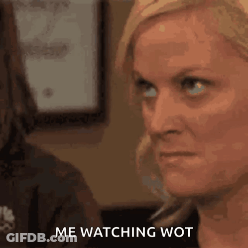 A Close Up Of A Woman 'S Face With The Words Me Watching Wot Written Below Her . GIF