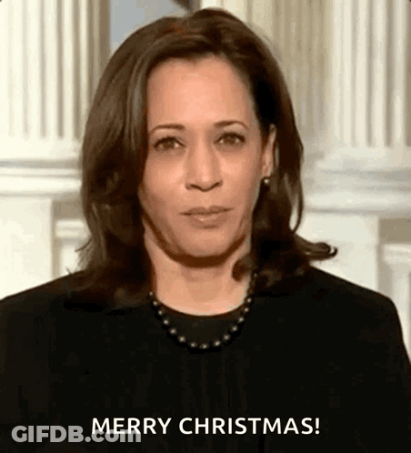 A Close Up Of A Woman 'S Face With The Words `` Merry Christmas '' Written On It . GIF