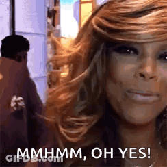 A Close Up Of A Woman 'S Face With The Words `` Mhmm , Oh Yes '' Written On It . GIF