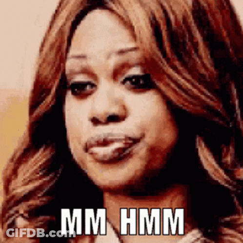 A Close Up Of A Woman 'S Face With The Words Mm Hmm Written On It GIF