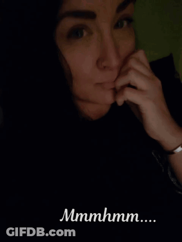 A Close Up Of A Woman 'S Face With The Words Mmmmhmm Written Below It GIF