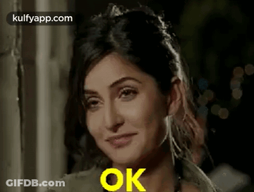A Close Up Of A Woman 'S Face With The Words `` Ok '' Written On It . GIF