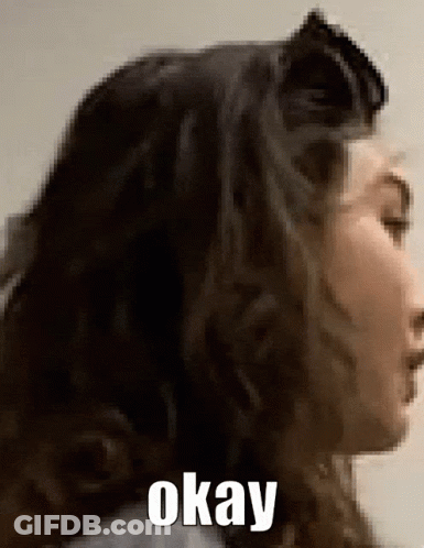 A Close Up Of A Woman 'S Face With The Words Okay Written On The Bottom GIF
