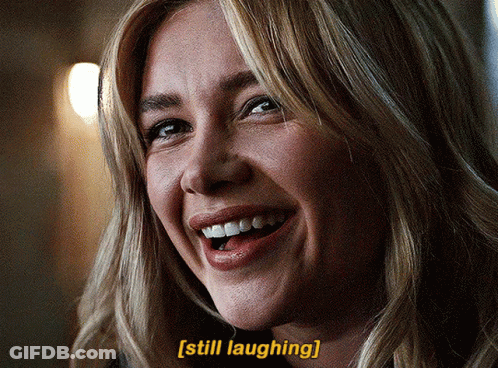 A Close Up Of A Woman 'S Face With The Words Still Laughing Below Her GIF