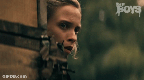 A Close Up Of A Woman 'S Face With The Words The Boys In The Background GIF
