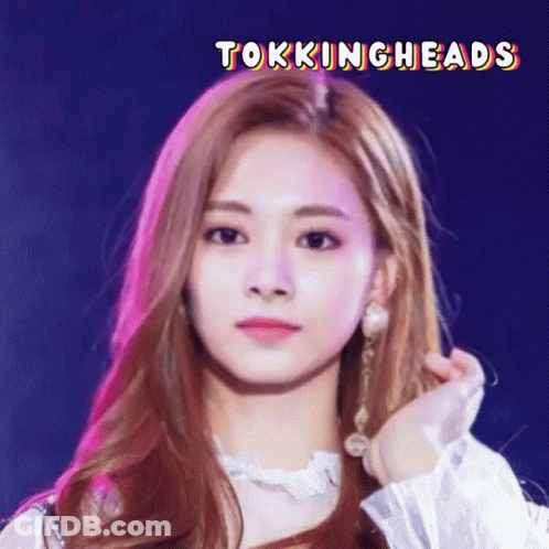 A Close Up Of A Woman 'S Face With The Words Tokingheads Written Above Her GIF