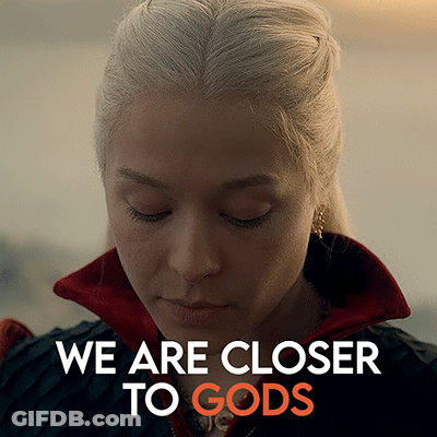 A Close Up Of A Woman 'S Face With The Words " We Are Closer To Gods " Above Her GIF