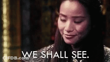 A Close Up Of A Woman 'S Face With The Words `` We Shall See '' Written On It . GIF