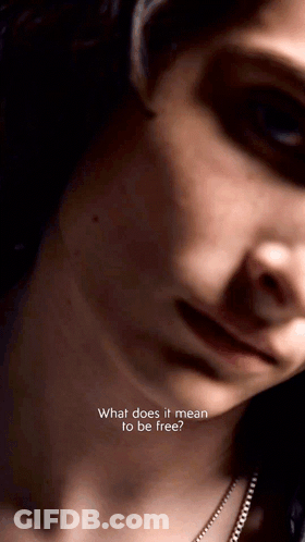 A Close Up Of A Woman 'S Face With The Words " What Does It Mean To Be Free " On The Bottom GIF
