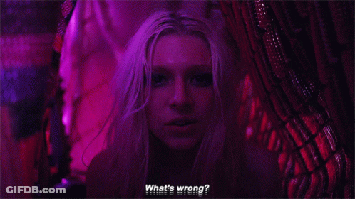 A Close Up Of A Woman 'S Face With The Words `` What 'S Wrong ? '' Written On The Bottom . GIF