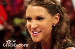 A Close Up Of A Woman 'S Face With The Words Wwe Live In The Background . GIF