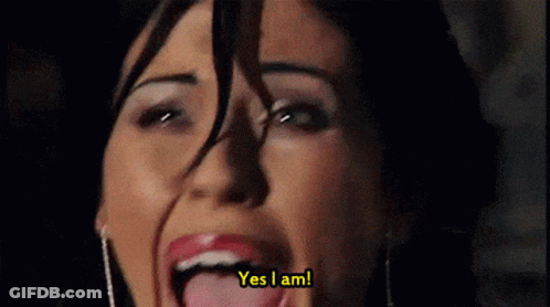 A Close Up Of A Woman 'S Face With The Words Yes I Am Behind Her GIF