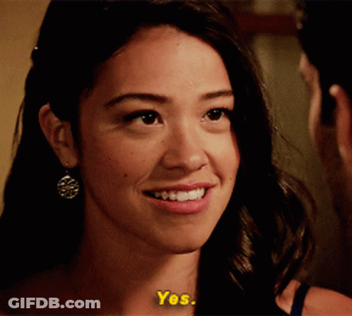 A Close Up Of A Woman 'S Face With The Words " Yes " On The Bottom GIF