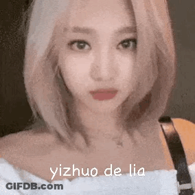A Close Up Of A Woman 'S Face With The Words Yizhuo De Lia Written On It . GIF