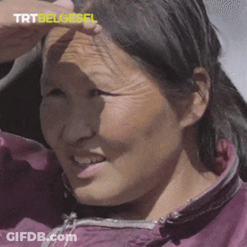 A Close Up Of A Woman 'S Face With Trtbelgesel Written In Yellow GIF