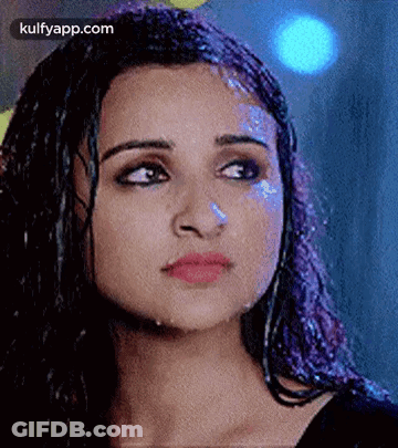A Close Up Of A Woman 'S Face With Water Coming Out Of Her Hair . GIF