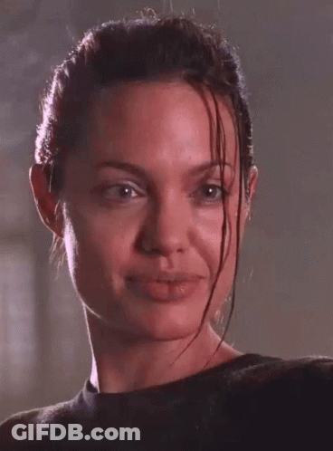 A Close Up Of A Woman 'S Face With Wet Hair Making A Funny Face GIF