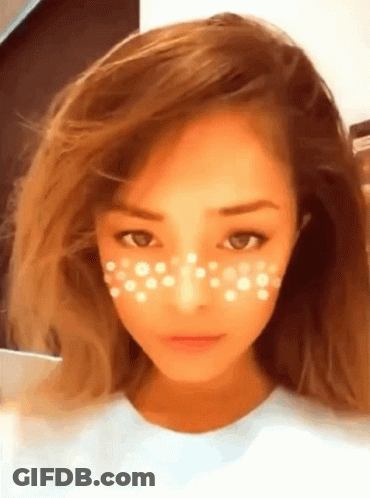 A Close Up Of A Woman 'S Face With White Dots On Her Face GIF