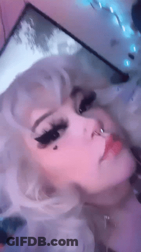 A Close Up Of A Woman 'S Face With White Hair And A Nose Ring GIF