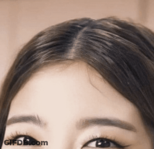 A Close Up Of A Woman 'S Forehead With Long Hair GIF