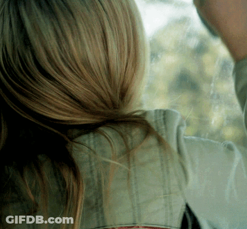 A Close Up Of A Woman 'S Hair And A Man 'S Face GIF