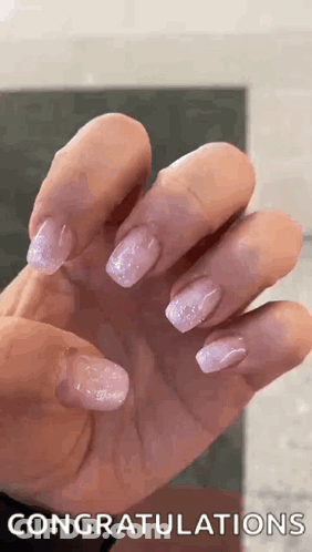 A Close Up Of A Woman 'S Hand With Purple Nails And The Words `` Congratulations '' Written On It . GIF