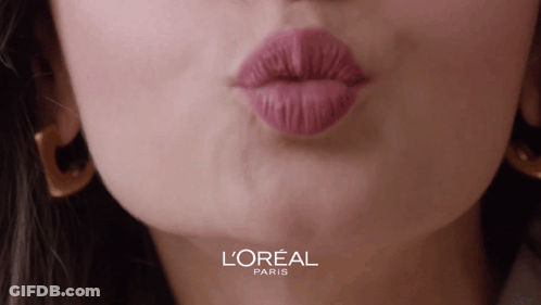 A Close Up Of A Woman 'S Lips With A L' Oreal Paris Logo Behind Her GIF