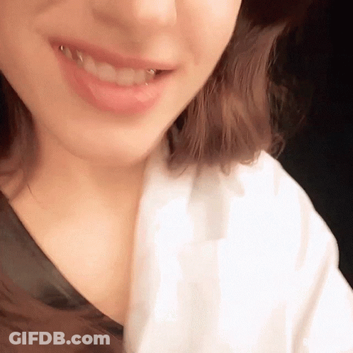A Close Up Of A Woman 'S Mouth With A Piercing In It GIF