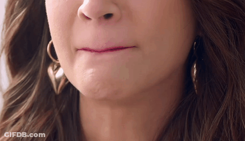 A Close Up Of A Woman 'S Mouth With Earrings GIF