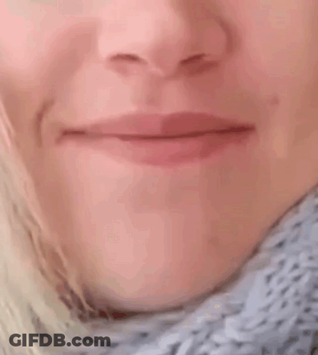 A Close Up Of A Woman 'S Mouth With Her Mouth Wide Open GIF