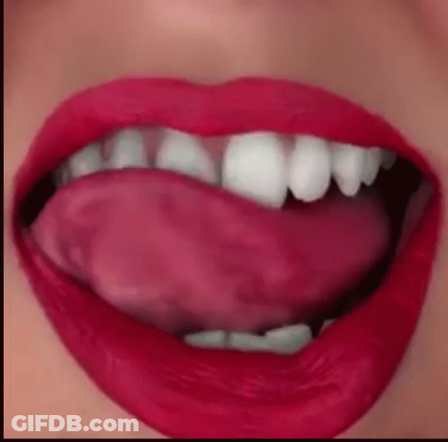 A Close Up Of A Woman 'S Mouth With Her Tongue Out GIF
