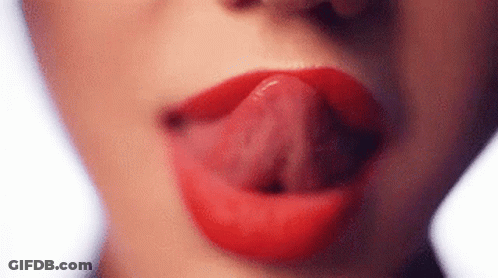 A Close Up Of A Woman 'S Mouth With Her Tongue Sticking Out . GIF