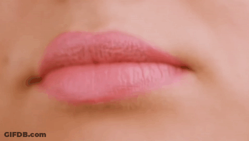 A Close Up Of A Woman 'S Mouth With Pink Lipstick . GIF