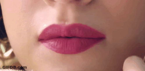A Close Up Of A Woman 'S Mouth With Pink Lipstick . GIF