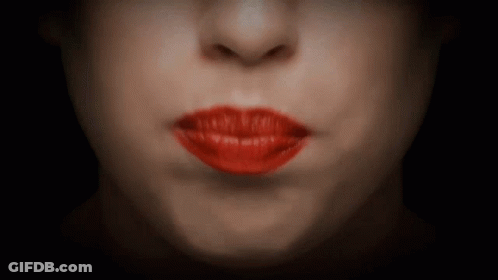 A Close Up Of A Woman 'S Mouth With Red Lips GIF