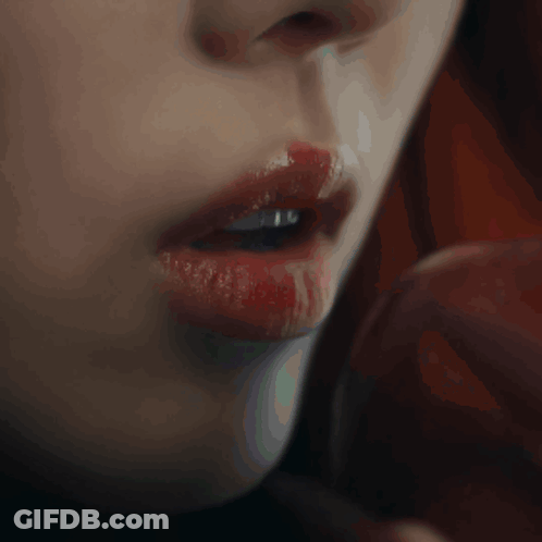 A Close Up Of A Woman 'S Mouth With Red Lipstick GIF