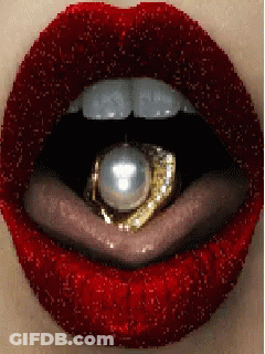 A Close Up Of A Woman 'S Mouth With Red Lipstick And A Gold Ring In It GIF