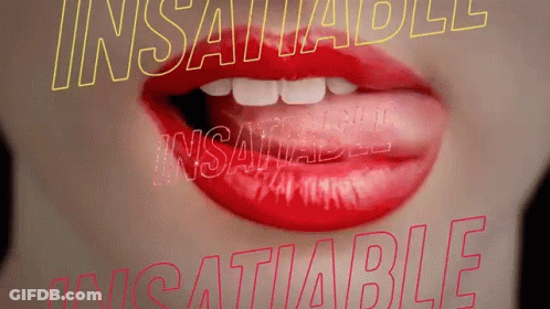 A Close Up Of A Woman 'S Mouth With Red Lipstick And The Words Insatiable And Insatiable Behind Her GIF