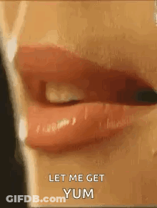 A Close Up Of A Woman 'S Mouth With Red Lipstick And The Words `` Let Me Get Yum '' . GIF