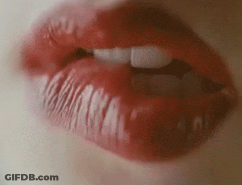A Close Up Of A Woman 'S Mouth With Red Lipstick And White Teeth GIF