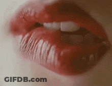 A Close Up Of A Woman 'S Mouth With Red Lipstick And White Teeth . GIF