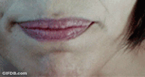 A Close Up Of A Woman 'S Mouth With Red Lipstick On GIF