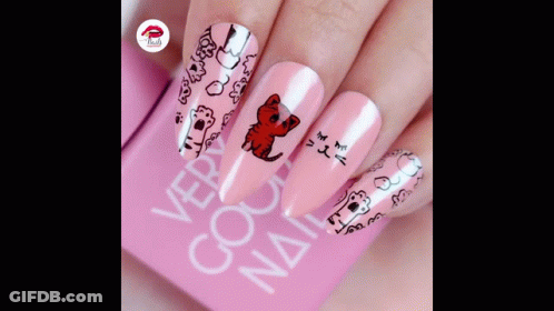 A Close Up Of A Woman 'S Nails With A Cat Design GIF