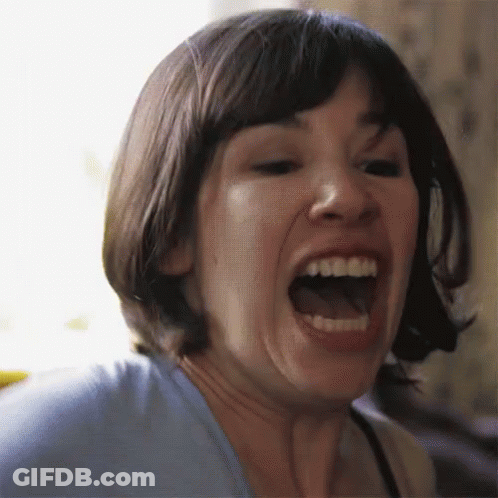 A Close Up Of A Woman Screaming With Her Mouth Wide Open GIF
