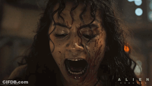 A Close Up Of A Woman Screaming With The Words Alien Romulus On The Bottom Right GIF