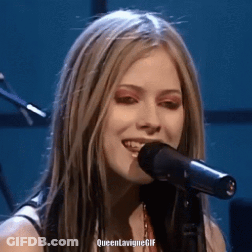 A Close Up Of A Woman Singing Into A Microphone With Queen Lavigne Gif Written On The Bottom GIF